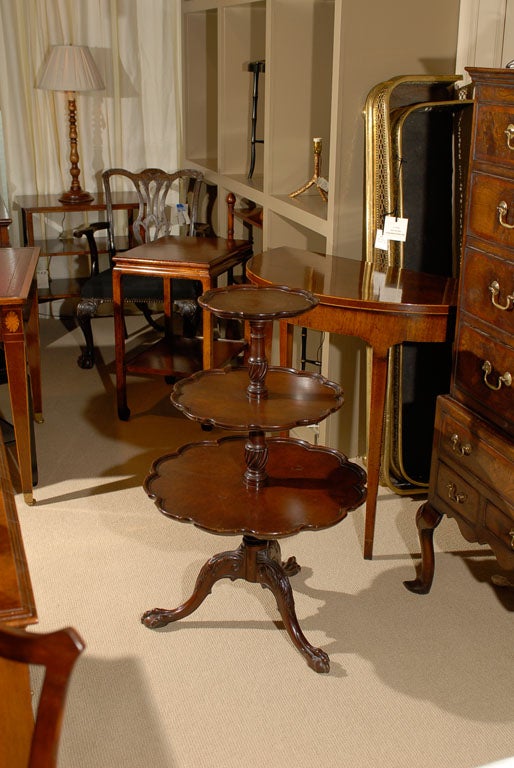 Mahogany dumbwaiter in exceptional condition. Three scalloped tiers with claw feet.