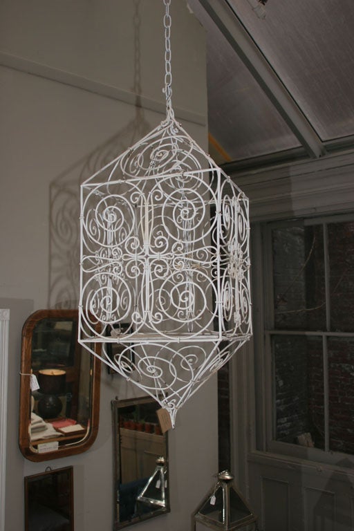 Fun and whimsical c1960s enameled steel candle lantern or decorative birdcage.  This piece works wonderfully with a large pillar candle hung from the ceiling.  It could also be hard-wired and used as an actual lighting fixture.  In the right room it