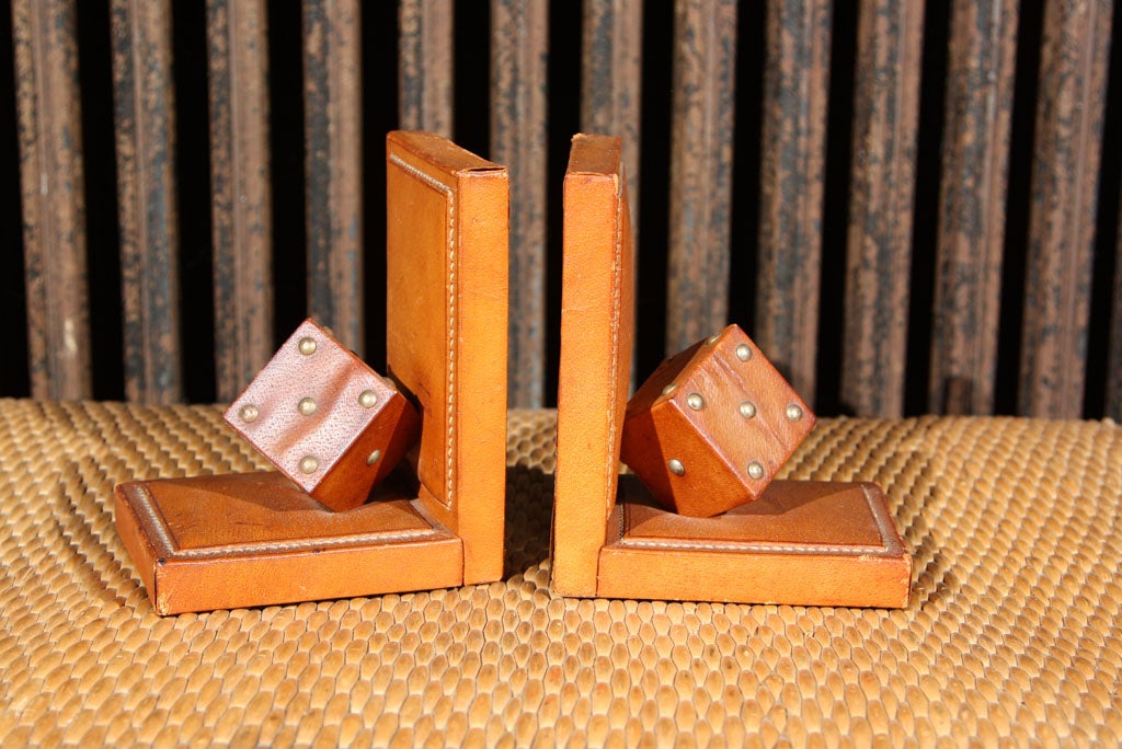 Pair of French stitched and studded brown leather dice bookends.