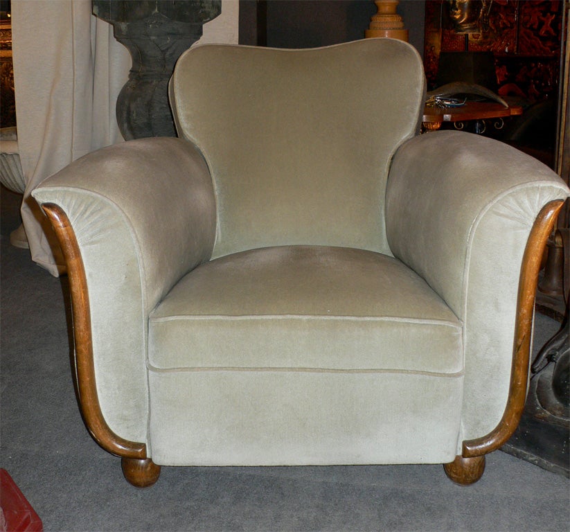 Two 1940s armchairs with wood elements, covered in the original light green velvet.