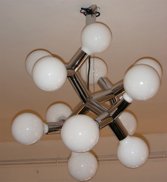 Swiss 1970s chandelier with chromed metal structure and 12 lights with white glass shades.