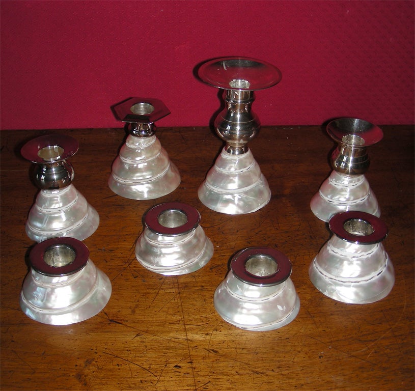 Eight 1990s candleholders by Frédérique Lombard Morel with shells and silver-tone metal. Tallest piece height 15 cm., diameter is the same for all.