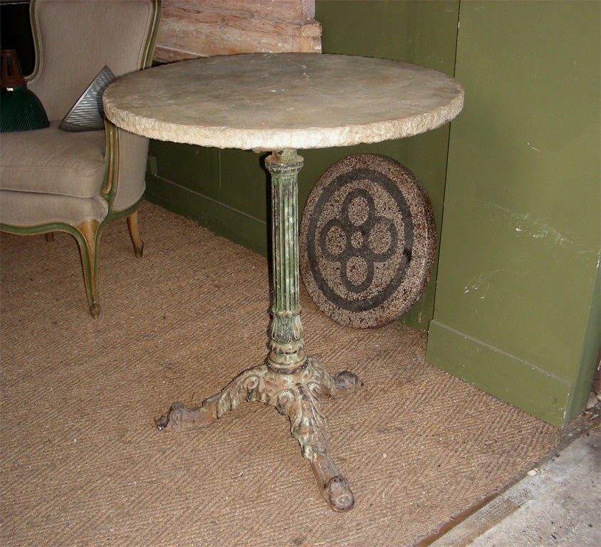 End of 19th century French bistrot table with base in cast iron and top surface in stone.