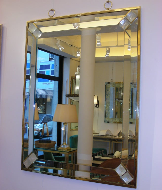 Large contemporary bevelled mirror by André Hayat with structure in gilt bronze, with pieces of rock crystal inserted diagonally in the corners.