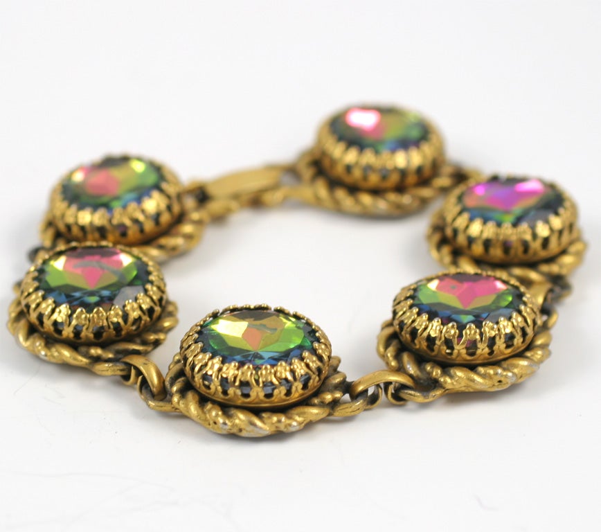 Six round, faceted, prong set, watermelon stones in the goldtone link bracelet designed by the legendary Elsa Schiaparelli.