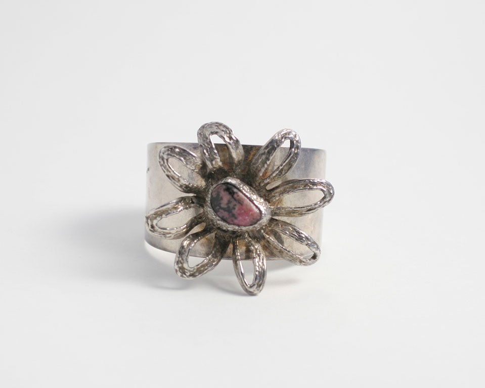 Wide silver cuff by Erik Dennung decorated with a large eight petal flower with a rose quartz center.   2