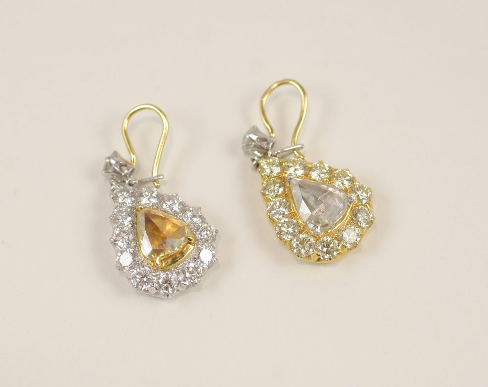 18K Yellow and White Rose Cut Diamond Pear Shaped Drop Earrings.

Each Stone is surrounded by full cut round brilliant diamonds.

Total Weight 4.62