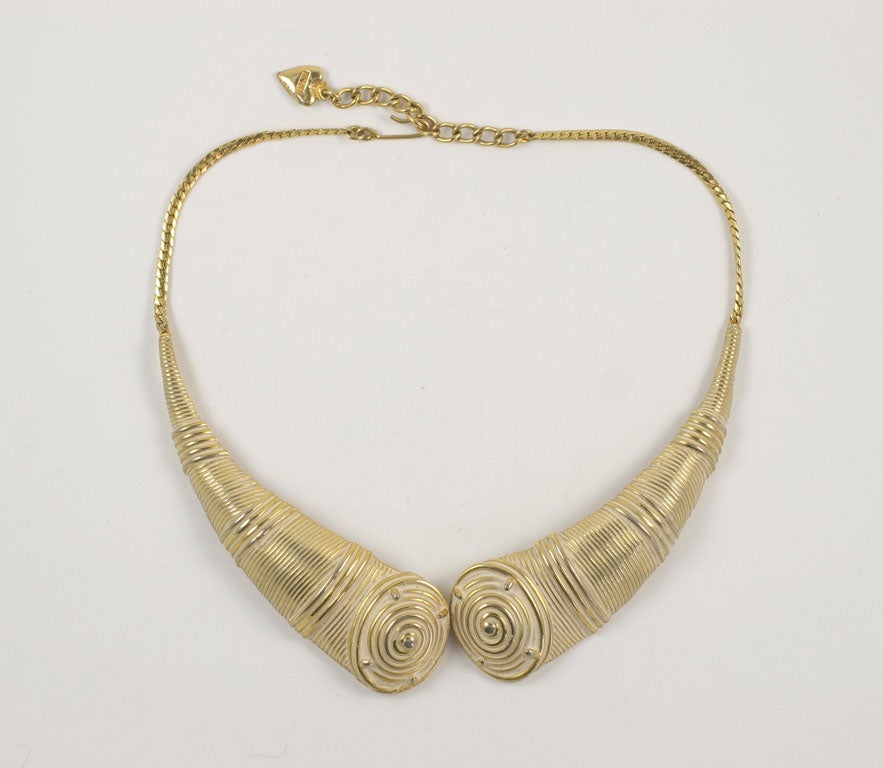 Necklace consists of two moveable segments backed with chain and hook closure. The lovely gold finish includes a subtle whitewash.