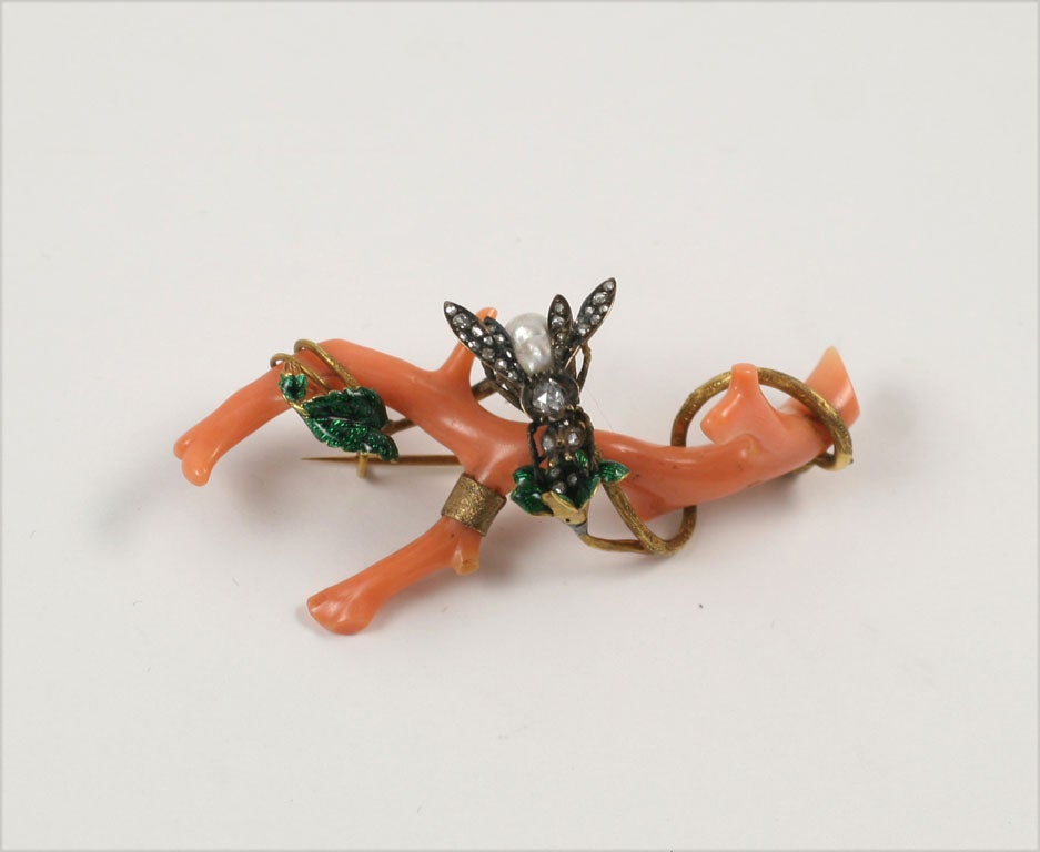Branch Coral Brooch with a Bee formed with a natural Pearl Body and Diamond Wings landing on a branch with enameled leaves & intertwining gold tendrils.  Formerly in the Collection of Ruth Ford. Ca. 1850-70.