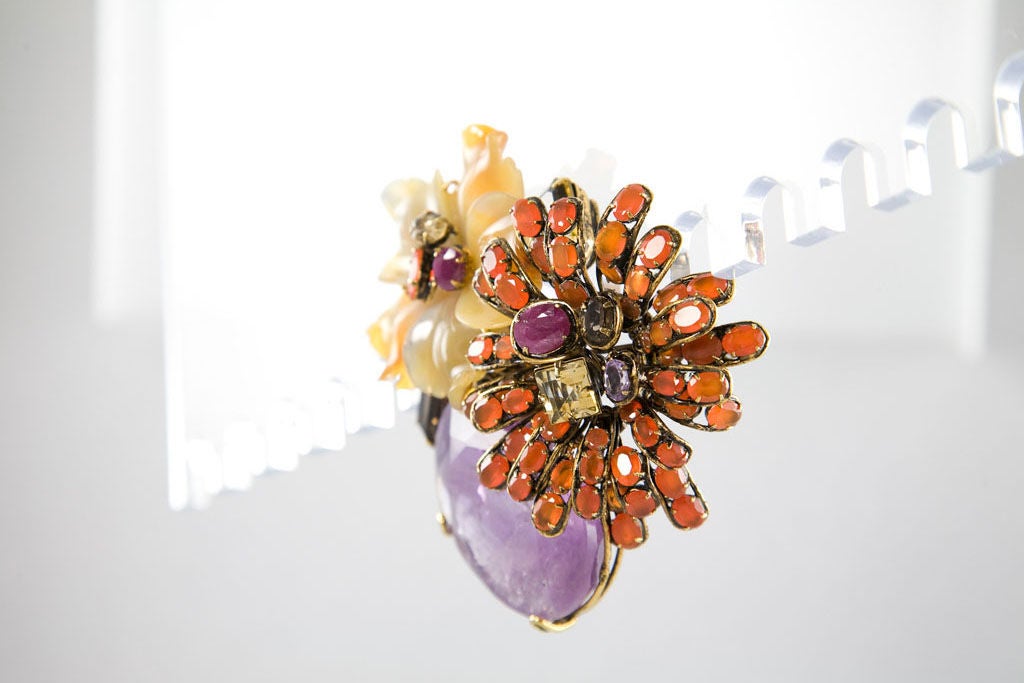 Beautiful and rare brooch designed by the talented Mr. Moini.  Features wonderful design along with a great array gems including a stunning faceted Amethyst, Citrines, Topaz, dirty Ruby, Agate, and Mexican Opals.