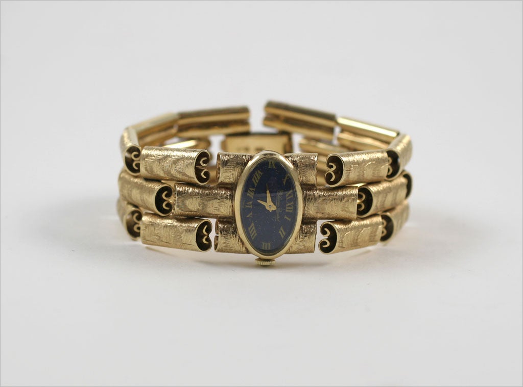 Stylized triple row Scroll Bracelet Watch with Lapis Enameled Face bearing Roman Numerals & signed Lucien Piccard & Swiss. Has a safety chain & is Signed Lucien Piccard - 14kt and  numbered C7072 on the reverse. Also marked 14kt on clasp