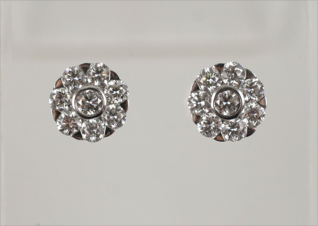 18 k gorgeous diamond stud like earrings. these studs look like single stones. they have very little metal on them, and they are quite sophisticated on.They are perfect for the understated attorney, or someone who simply, isn't the 
