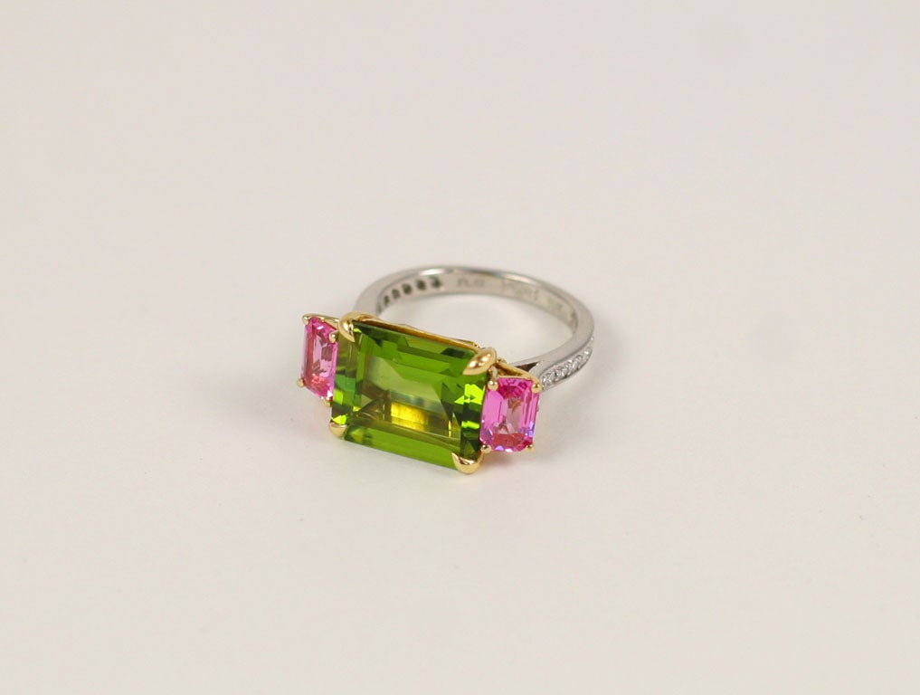 Emerald cut peridot approximately 4.50 carats.<br />
2 emerald cut pink sapphires approximately 1.20<br />
26 diamonds approximately .50