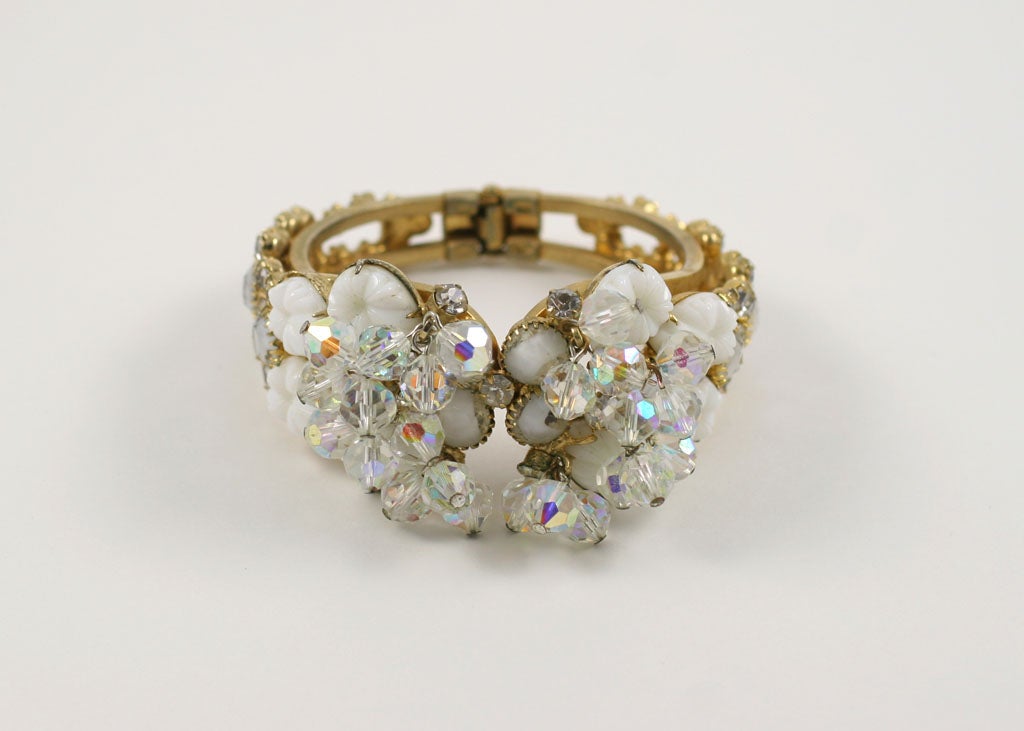 Crystal, rhinestone, and white beads and stones on a goldtone clamp style cuff -very playful!
