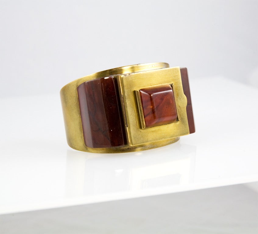 This c1935 bakelite and brass cuff was apparently one of several designs comissioned by Josephine Baker to give as gifts.  A photograph of this bracelet (in black bakelite) and more information can be found in 