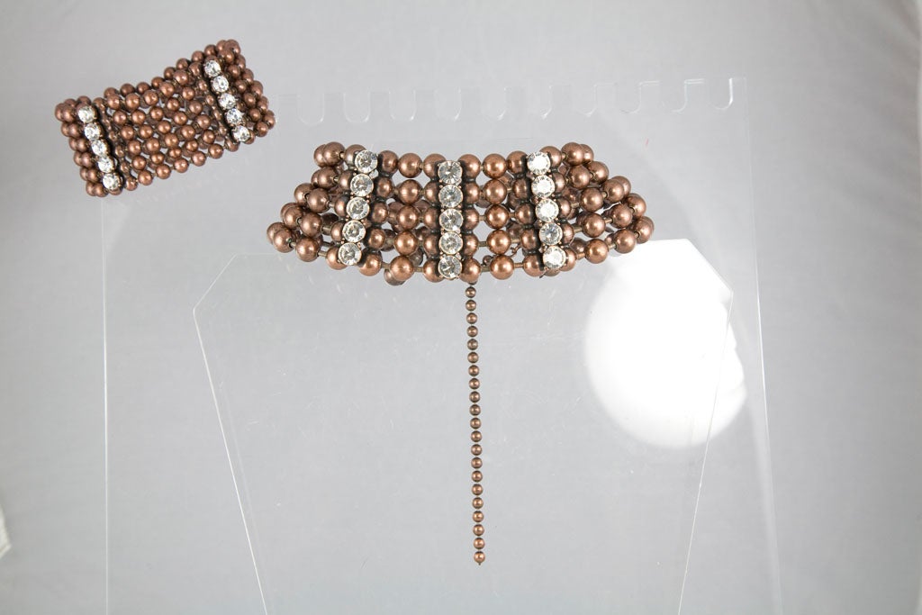 Really great choker featuring 5 rows of bronze bead accented by 3 rows of rhinestones.  The matching bracelet is also 5 rows of bead with the same rhinestones.  The price listed is for both pieces which may be purchased separately, the necklace is
