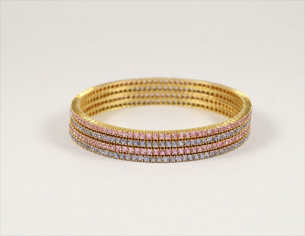A set of Four Fabulous Pink and Blue Sapphire Bangle Bracelets, with over 80.00 Carats of Color...Set in 18 Karat Gold