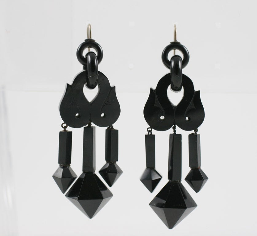 Thrilling Whitby Jet earrings, the most exciting pair we have found to date, are here in their full glory.  On the ear you will enjoy their weightless drama. Suspended from gold ear wires, each of the six sections of these earrings move freely and