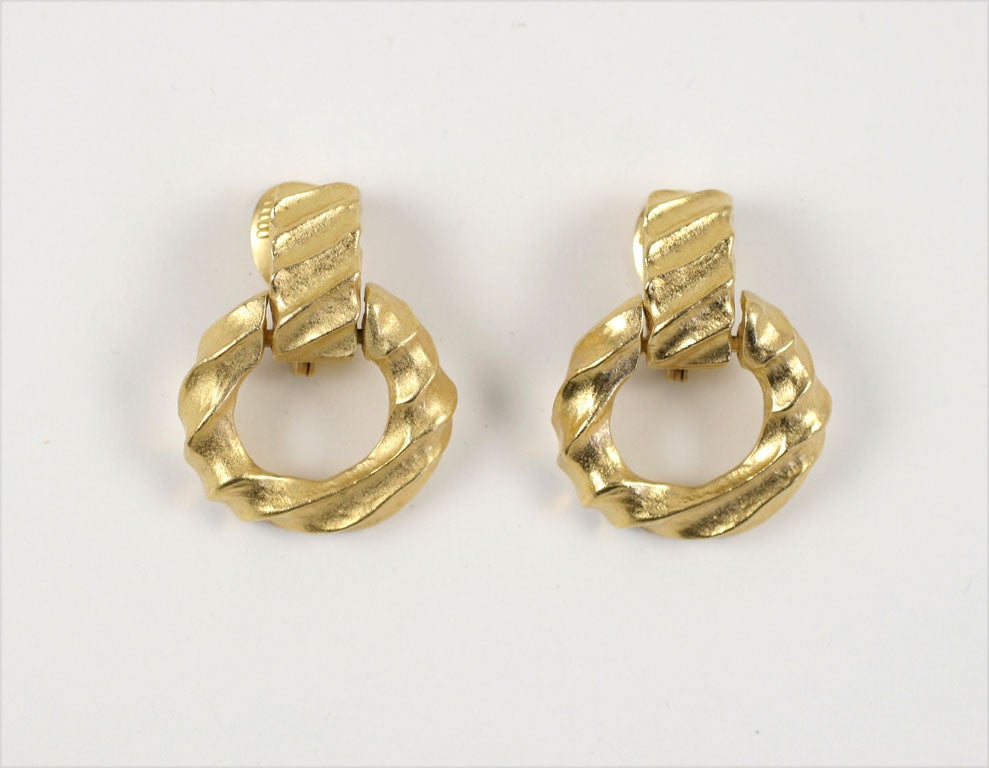 Soft goldtone finish, diagonal raised pattern hoop earrings.