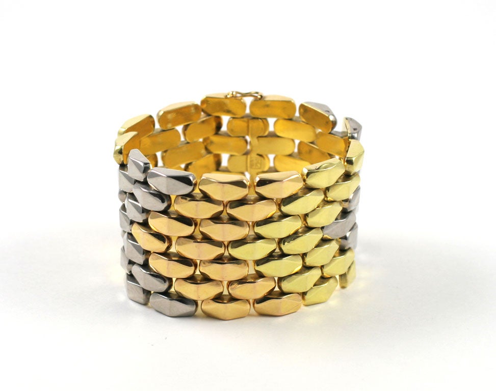 Wide Three Color Gold Bracelet, designed as seven rows of faceted links, can be reversed for a different, very modern look. 18.4cm, (7 1/4 inch) x 4.2cm (1 5/8in)