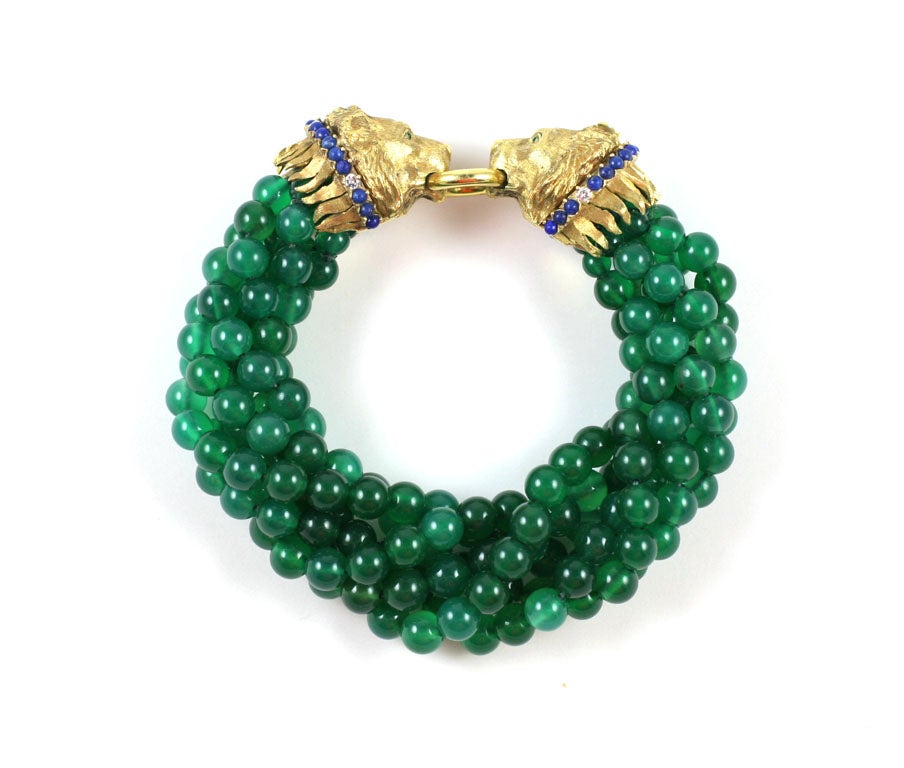 Six Strand Chrysoprase Bead Torsade Bracelet, the clasp designed as two textured Gold Lion Head biting on a gold ring, each lion head decorated with cabochon lapis lazuli, brilliant-cut diamonds and cabochon emerals eyes. length when not twisted: 9