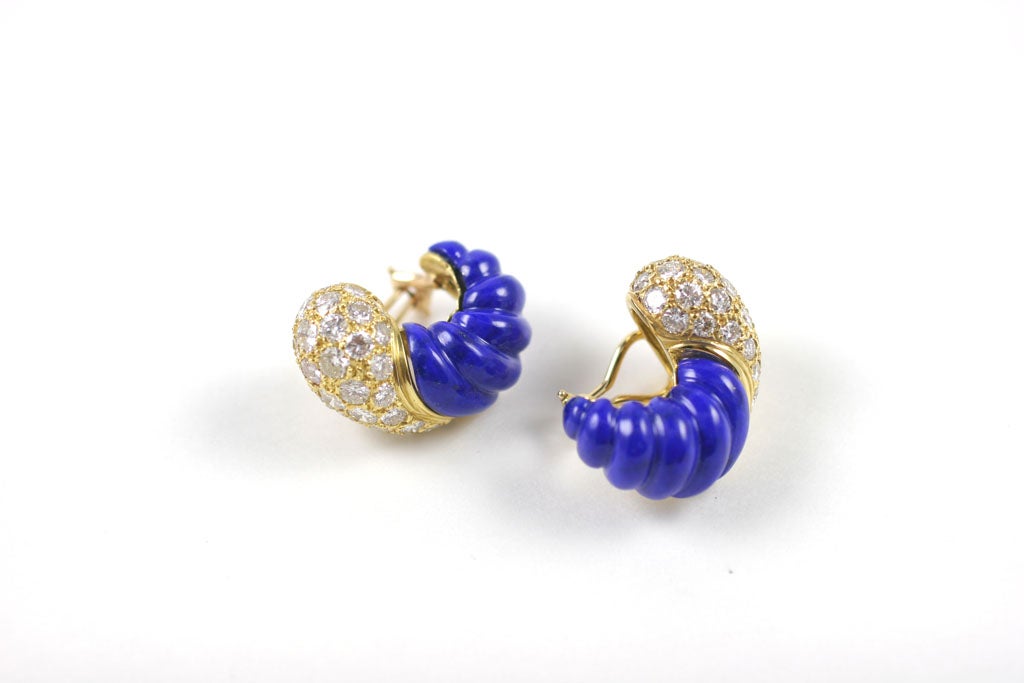 Each clip crescent shaped, the bombe' top set with brilliant-cut diamonds, the bottom half set with a carved lapis lazuli