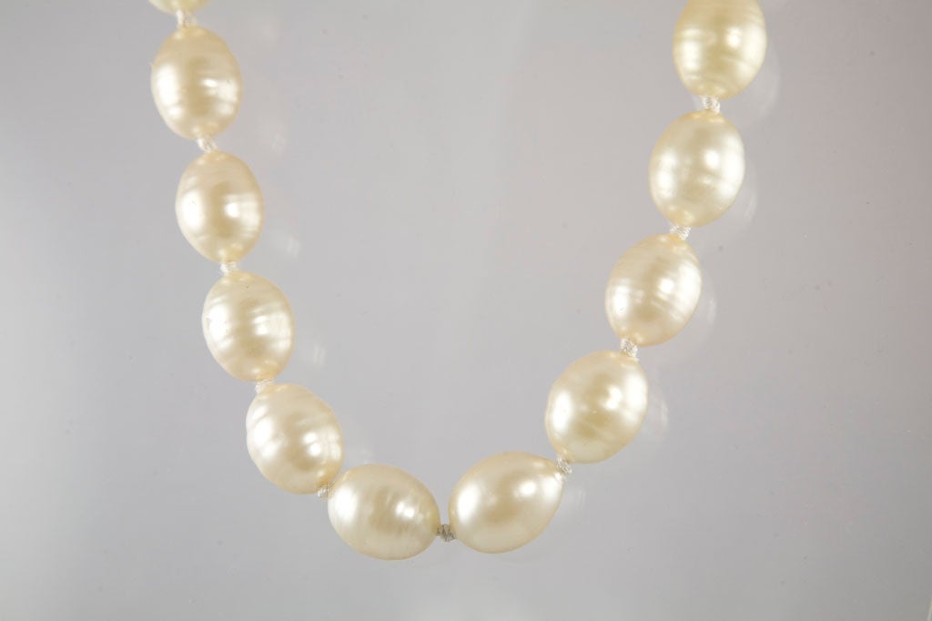 Fantastic strand of oversized pearls with a gilt metal ring and toggle closure.  Toggle is marked 
