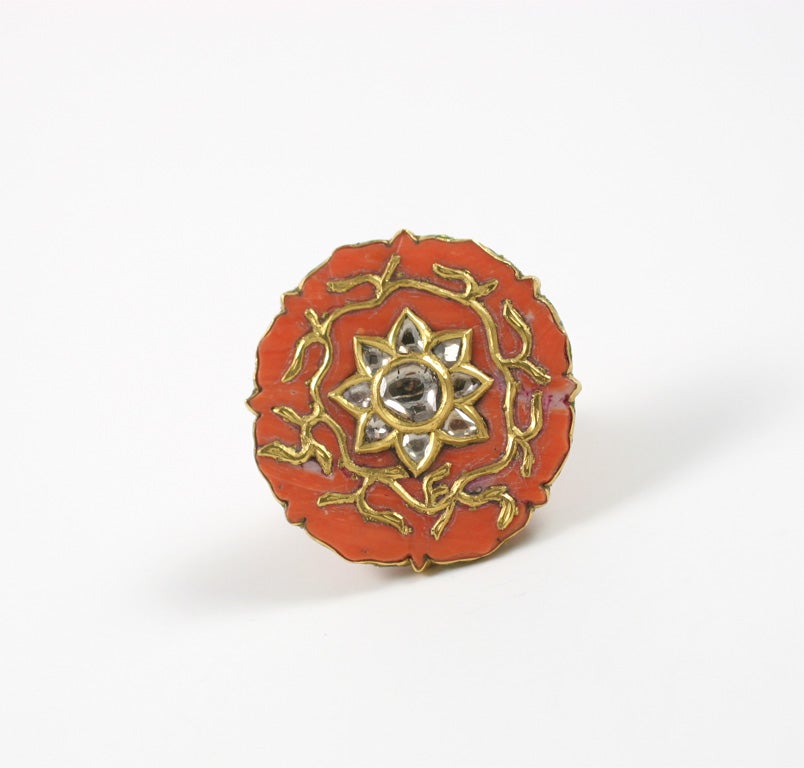 A coral ring set in 18kt yellow gold. The  ring is decorated with enamel and is set with rose cut diamonds in the center.<br />
From the Jaipur Collection Designed by Rebecca Koven