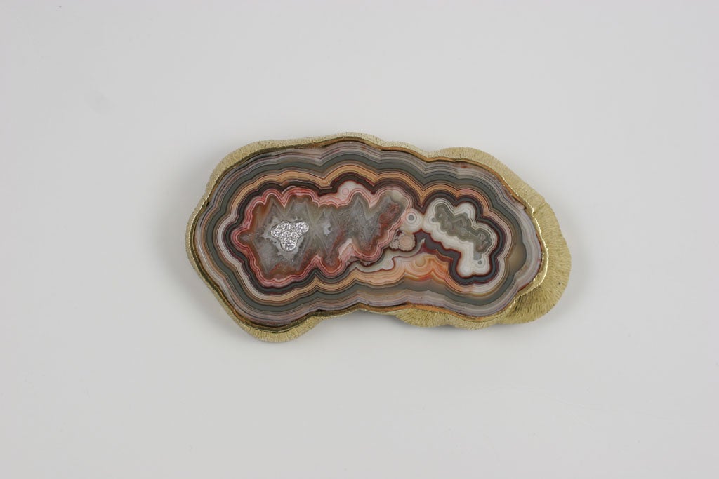 A spectacular piece of jewelry from the father of the Modern British jewelry movement. Grima’s love for working with natural stones such as agate is well known. The beauty of this brooch lies in the amazing colors of the polished agate, set off by