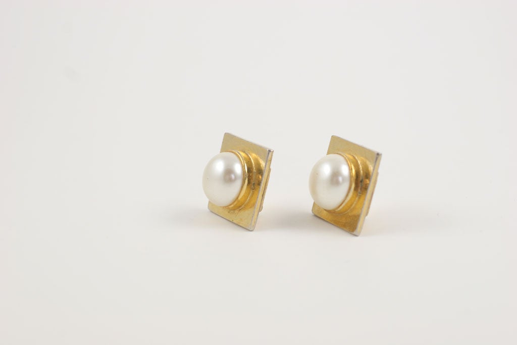 Square goldtone earrings set with large faux mabe pearls.  Signed YSL.