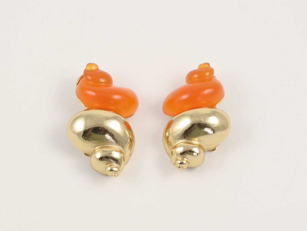 Large goldtone and orange resin conch shell shaped earring by Christian Dior.