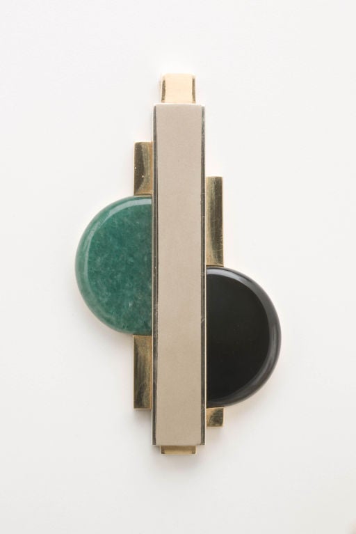 A stunning and important pendant by Art Deco designer Gerard Sandoz.  This pendant with its combination of brushed and polished 18 karat gold is set with demi lunes of onyx and aventurine.  The pendant is signed on the back with Sandoz script