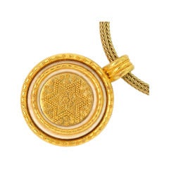 DANIEL BRUSH. A yellow gold and ivory pendant