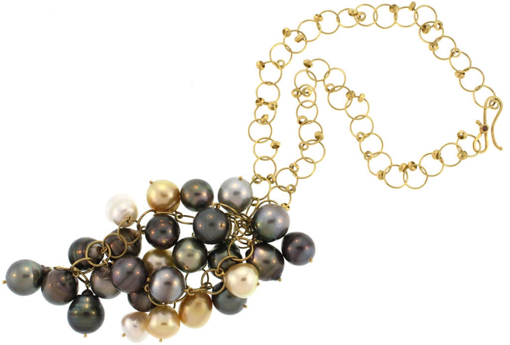 A beautiful and striking cluster of 26 south sea pearls hang from a delicate 18k gold, bubble like chain. A small rose cut diamond adorns the clasp. The pearl cluster measures 4.5 in length and 2.5 in width.  The chain is 17.5 inches in length and