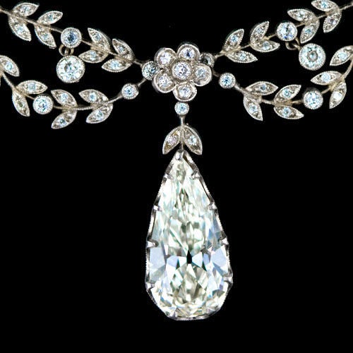 The most delightful Belle Epoque garland style diamond necklace. This platinum necklace highlights a stunning 4.36 carat antique pear cut diamond suspended from a festoon of delicate garlands and flower motifs glittering with small antique old mine