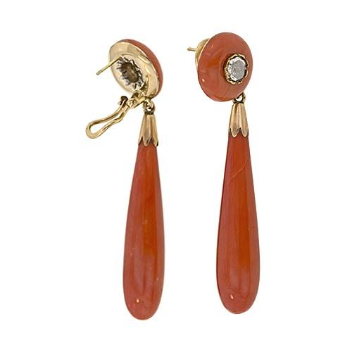 Coral was a favorite gem during the Victorian period and these earrings are a grand example of their use. The large pendeloque drops are suspended from a circular surmount inset with a large rose cut diamond. This coral is most likely from the