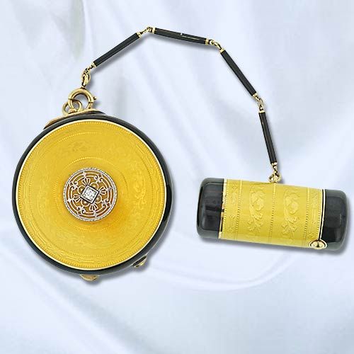 Early 20th century fabulous Tiffany & Co. yellow and black guilloche enameled round compact and lipstick case in 14K yellow gold. The compact is set with a round cut diamond (.05 carat, G-H color, VS clarity) in the center with a platinum foliate