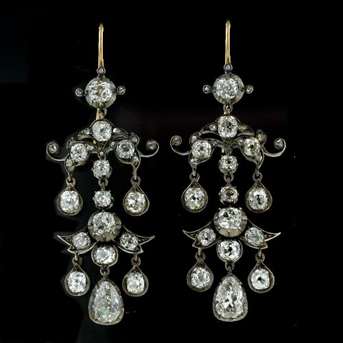 Outstanding Antique silver over gold diamond chandelier earrings. 9.00 carats of antique cushion, old mine and antique pear cut diamonds cascade from the ear in these pagoda style original Victorian earrings.<br />
<br />
Inventory No. 20-1-1742