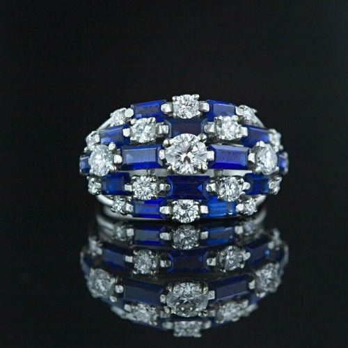 A signature design by the great American jeweler. Five stepped rows of alternating round bright white diamonds and brilliant blue baguette sapphires create this renowned classic design. Timeless. Ring size 5.<br />
<br />
Inventory No. 30-1-1882
