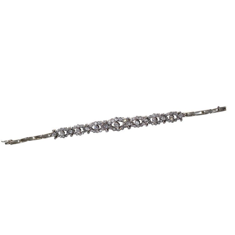 PLEASE NOTE: OUR PRICE IS FULLY INCLUSIVE OF SHIPPING, IMPORTATION TAXES & DUTIES

An early 20th century diamond bracelet, the seven slightly graduated oval clusters set throughout with cushion shaped, old brilliant, old cut and rose cut diamonds,
