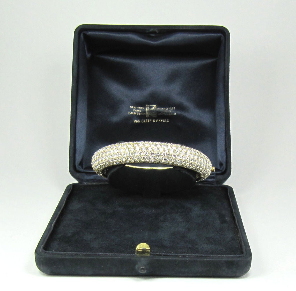 Stunning and chic estate 18k gold and diamond bangle bracelet, by Van Cleef & Arpels.  A beautiful bangle bracelet that is light as a feather and with tons of brilliant fire. Made in 18k yellow gold, it is set with approx. 30.0cts of lively high