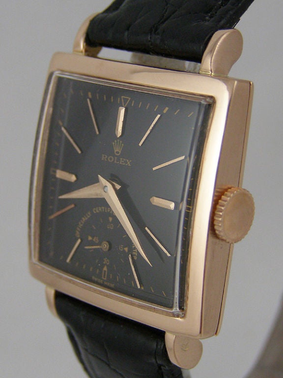 Rolex 14K PG square case dress model ref #4470 square 27.5mm case circa 1950's with glossy black dial with pink gold appied indexes and pointy dauphine hands. 17 jewel calibre 10 1/2 manual wind movement with subsidiary seconds. Great looking medium
