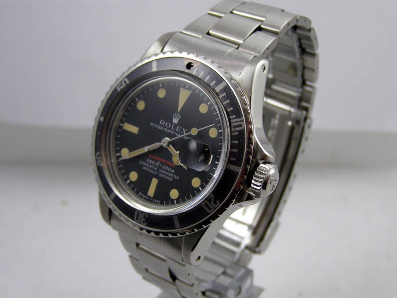 Rolex SS Submariner with date ref# 1680 serial# 3.3 million circa 1972 II/72 matte black dial 660ft=200m with pleasing patina'd luminous indexes and hands and faded elapsed time insert. Folded link flip lock bracelet ref 9315 with #380 endpeices.