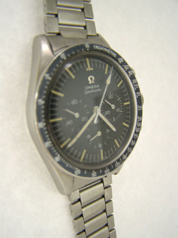 Omega SS Speedmaster Non Professional no crown guards case, straight lugs reference # S105.003-64 circa 1964. Original matte black stepped dial with white printing and patina'd luminous indexes and hands and applied silver Omega logo. Black