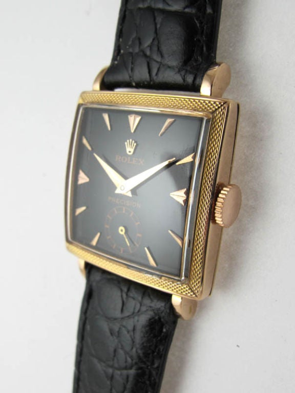 Rolex 18K PG square dress model ref # 8612 27 x 36mm florentine finish bezel circa 1950's glossy black dial with pink gold applied indexes and PG tapered dauphine hands 17 jewel manual wind 10 1/2 hunter movement with subsidiary seconds. A great