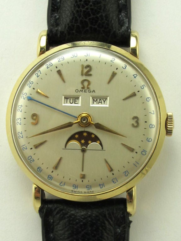 Omega 14K YG triple calendar moonphase ref # 2473 34mm diameter snap back case circa 1950 with beautiful original silver satin dial with gold applied indexes and tapered gold alpha hands. Calibre 381 17 jewel manual wind movement. 3 recessed buttons