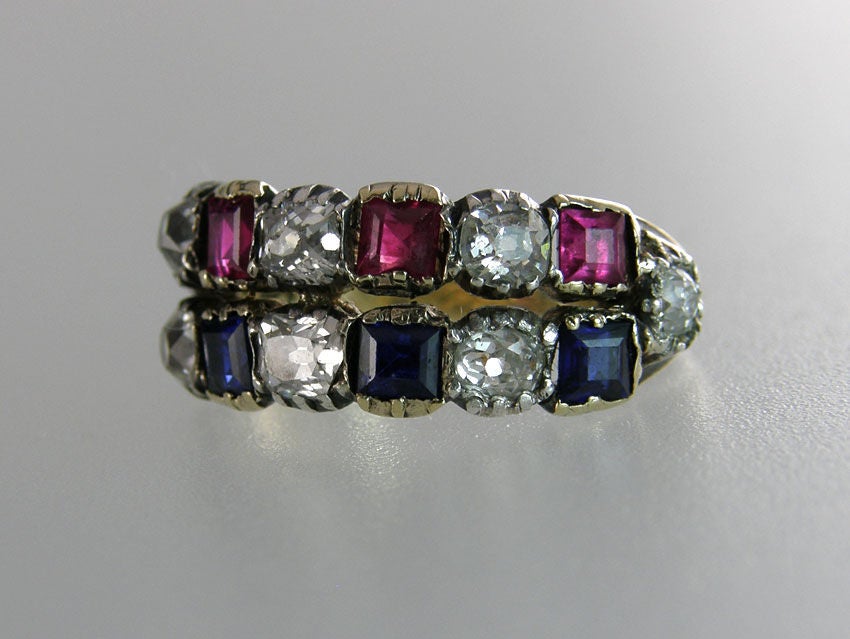 Victorian band ring set with 8 old mine cut diamonds (approx. 0.80cts) 4 square rubies and 4 square sapphires. Size 4 1/2