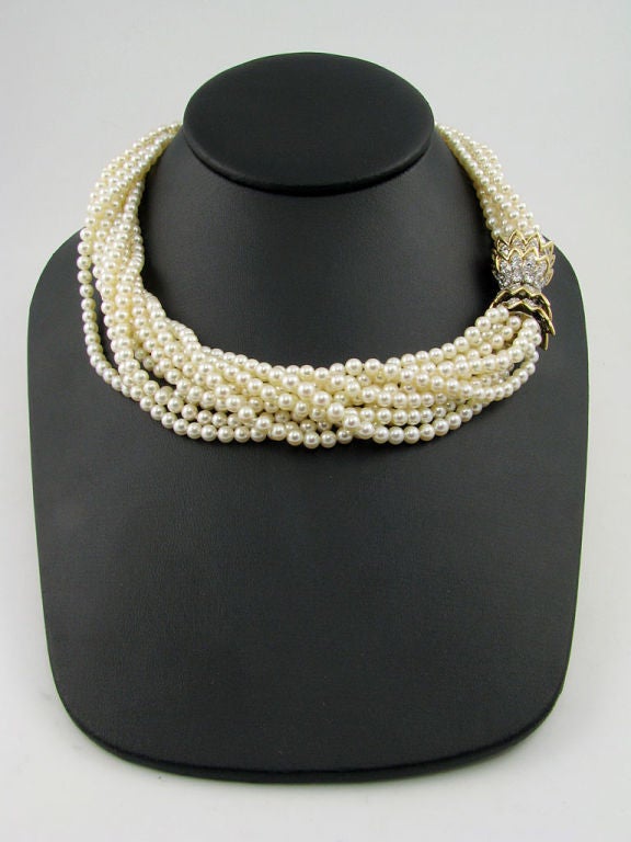 An 18 karat yellow gold, diamond, pearl and coral torsade necklace/bracelet set.  Signed Tiffany & Co. Schlumberger.  The set is comprised of an 18 karat yellow gold and diamond tulip clasp that is set with 130 diamonds weighing approximately 5.10