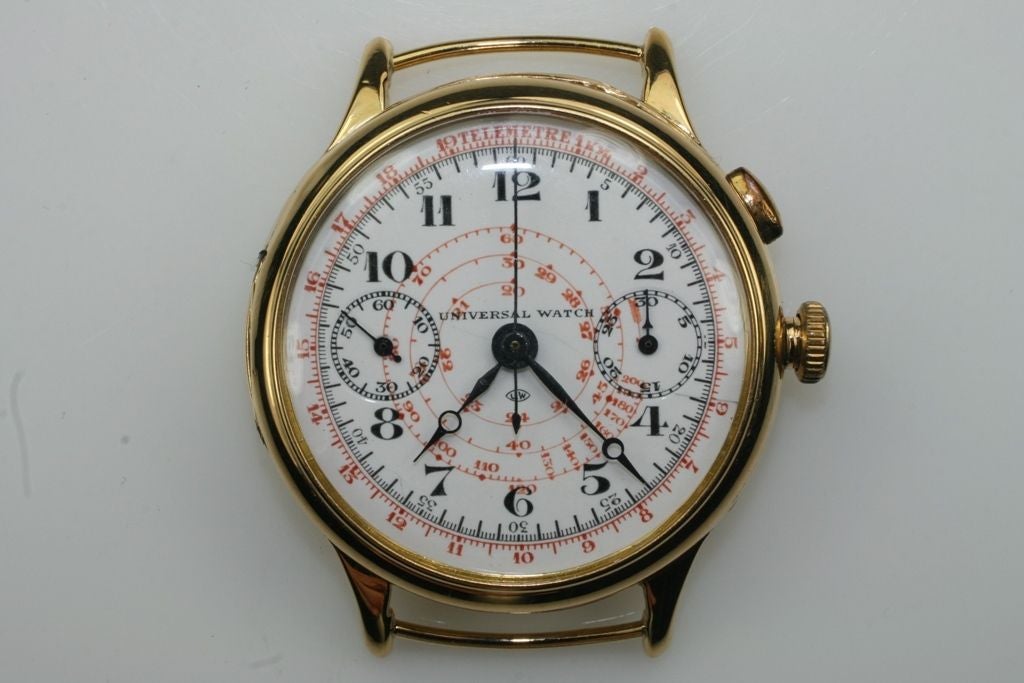 This is a vintage Universal One Button Chronograph in 18k yellow gold case, wire lugs, hinged back case, white enamel dial with telemetre tracking and a plastic crystal. The manual wind movement is a caliber 166.
