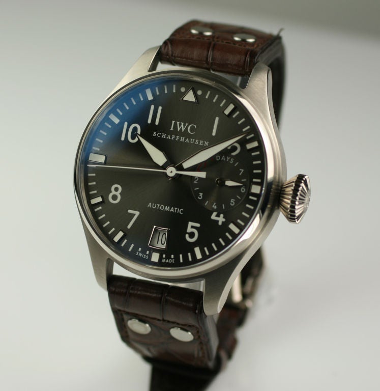 IWC (International Watch Company) Big Pilots watch in 18k white gold 46.2mm case has a special metallic slate grey dial,  extra large mushroom shaped crown,  brown leather strap with a IWC deployant buckle and comes with box/papers.  The automatic